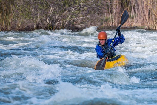 A kayaker skillfully navigates wild rapids in an exhilarating outdoor whitewater adventure.
